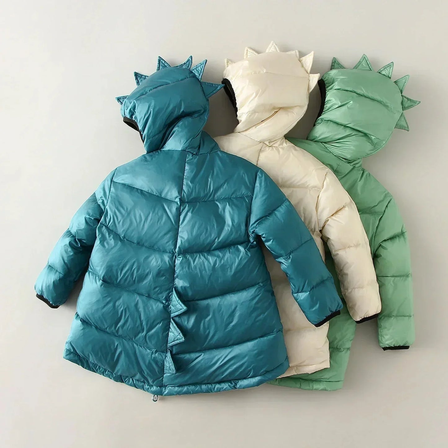 Adventure-ready green dino puffer jacket for kids, a warm, waterproof winter coat for playful exploration.