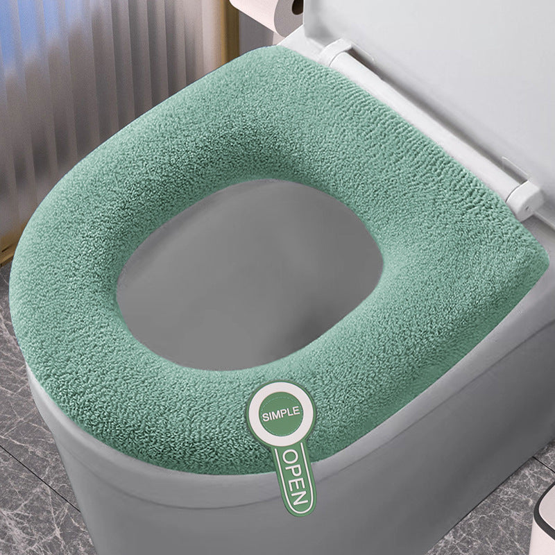 Soft polyester toilet seat cover, adds warmth & comfort, stylish bathroom decor accessory.