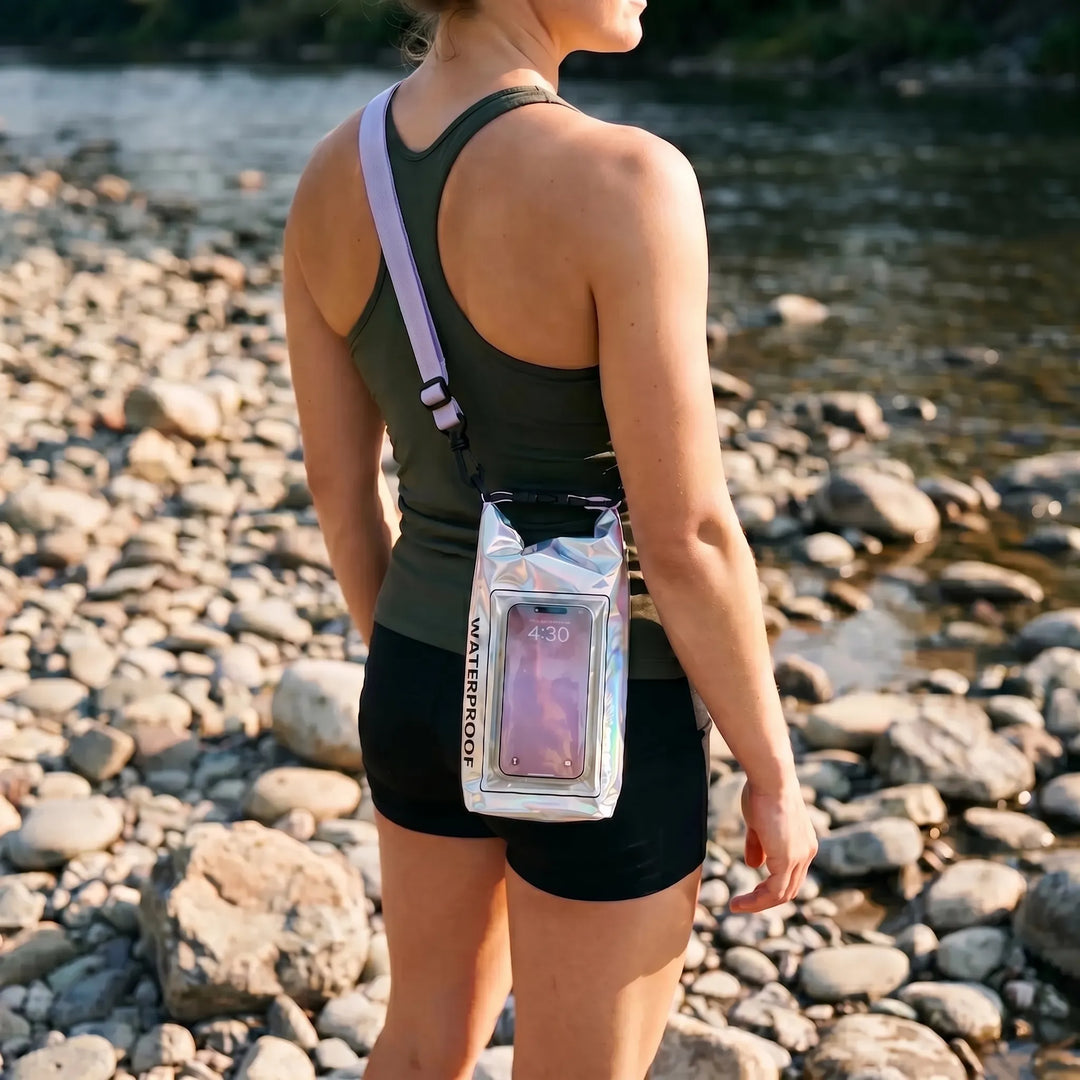 Waterproof roll-top dry bag with clear touchscreen window for phone access on water sports.