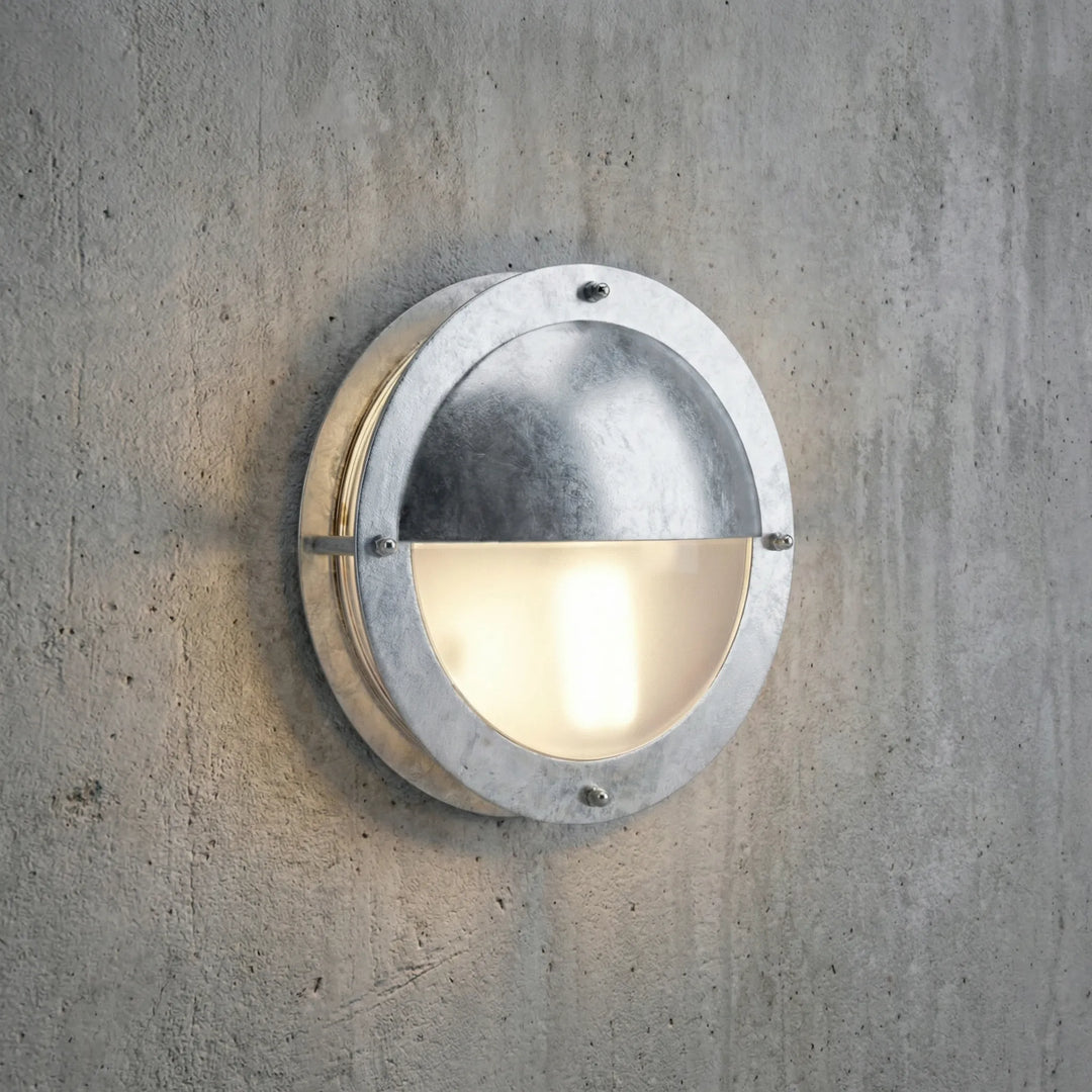 Modern round dimmable wall sconce, galvanized steel. Weatherproof exterior lighting for stylish outdoor spaces.