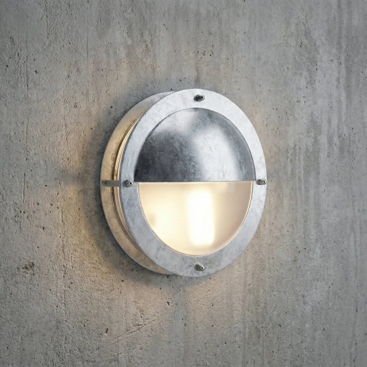 Modern round dimmable wall sconce, galvanized steel. Weatherproof exterior lighting for stylish outdoor spaces.