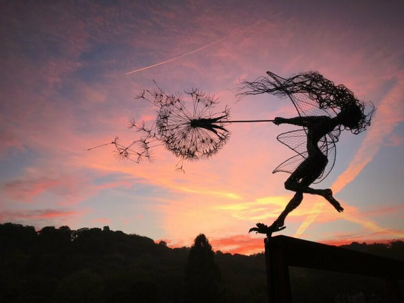 Whimsical metal fairy & dandelion garden stake, perfect for adding magic to outdoor living spaces.