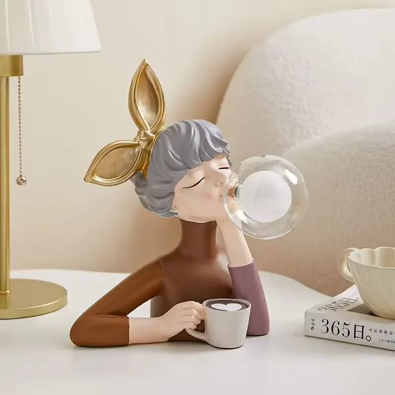 Unique whimsical girl figurine lamp, a detailed resin sculpture adding an artistic and ambient light accent to home decor.