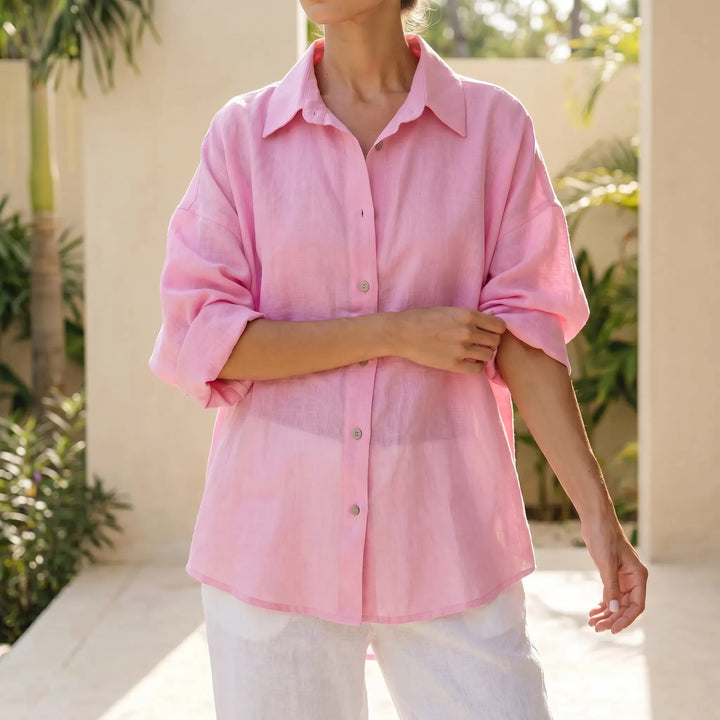 White oversized button-down shirt for women, a casual and relaxed fit long sleeve top for everyday wear.