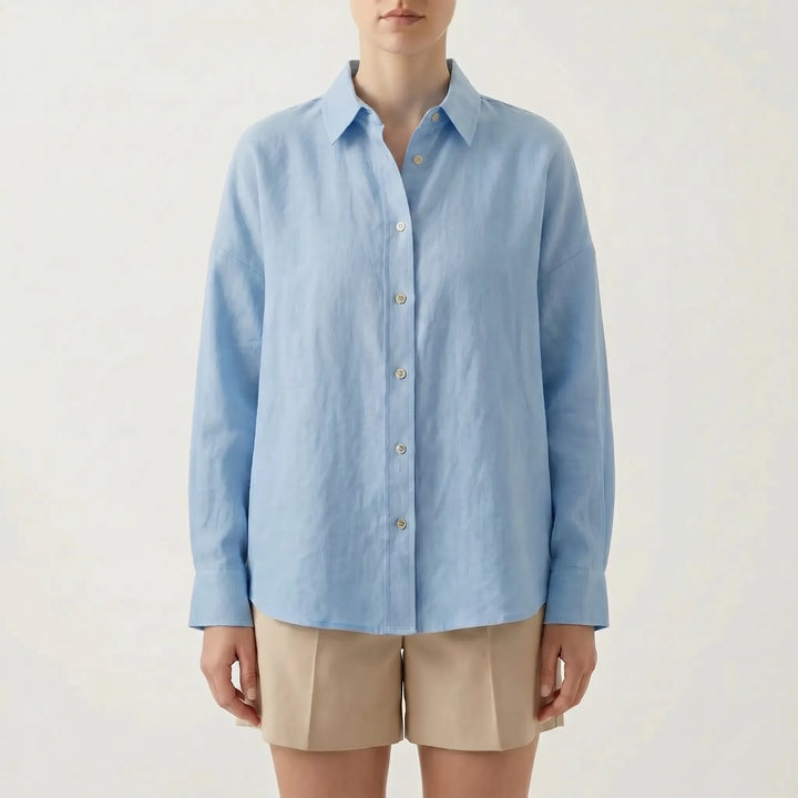 Effortless white oversized button-down shirt for women, a chic long sleeve casual top for relaxed summer fashion.