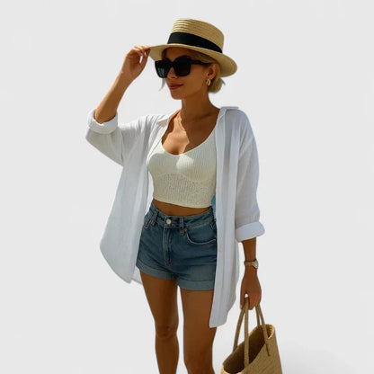 White women's elegant bohemian blouse, relaxed fit summer top with intricate embroidery detail. Casual chic style.