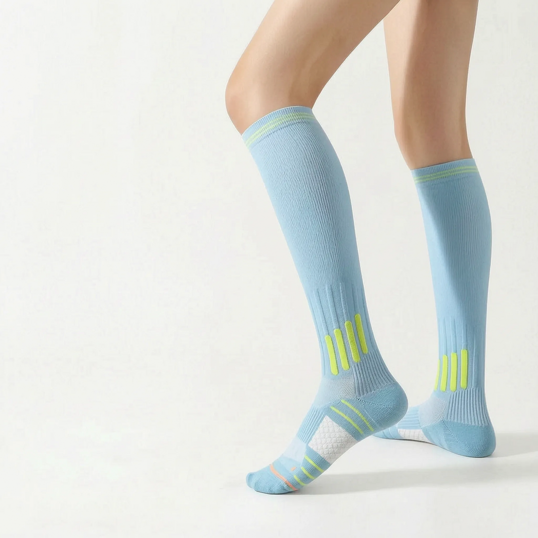 Sporty white knee-high running socks, ideal activewear for women.