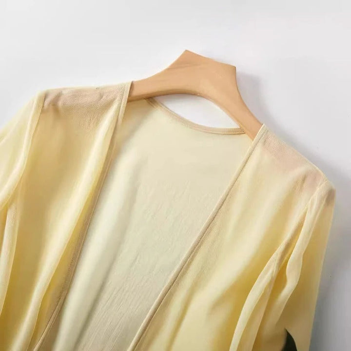 Elegant women's sheer lightweight cardigan with flowing open-front design. Versatile summer cover-up for chic looks.