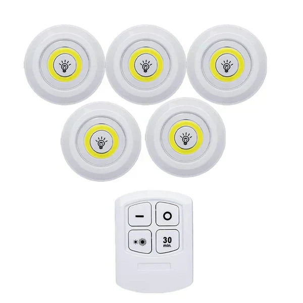 Wireless LED puck lights illuminating collectibles in a display case, perfect accent lighting.
