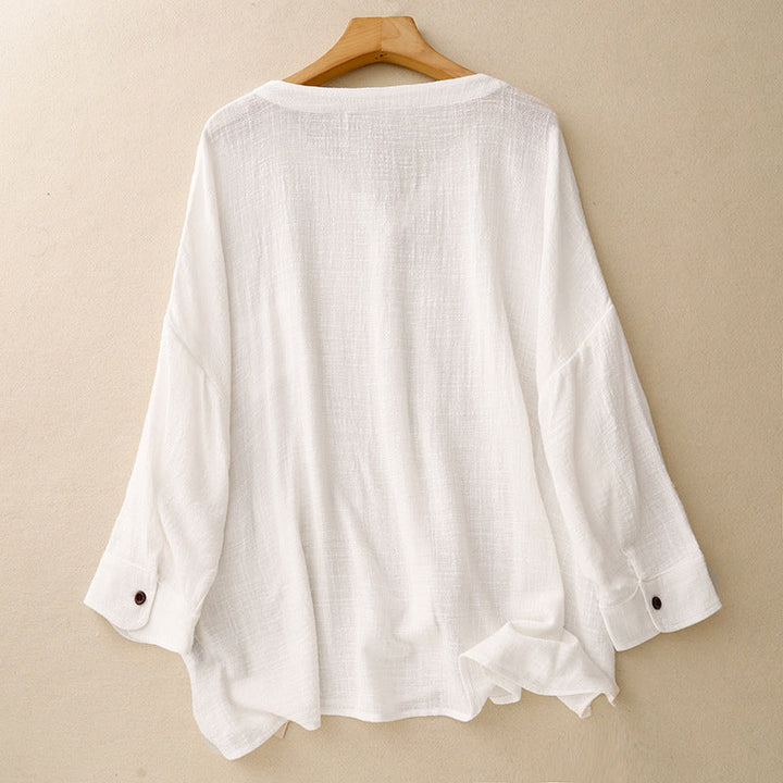 Stylish women's relaxed fit button-up shirt with an effortless drape and long sleeves, great for elegant spring casual wear.