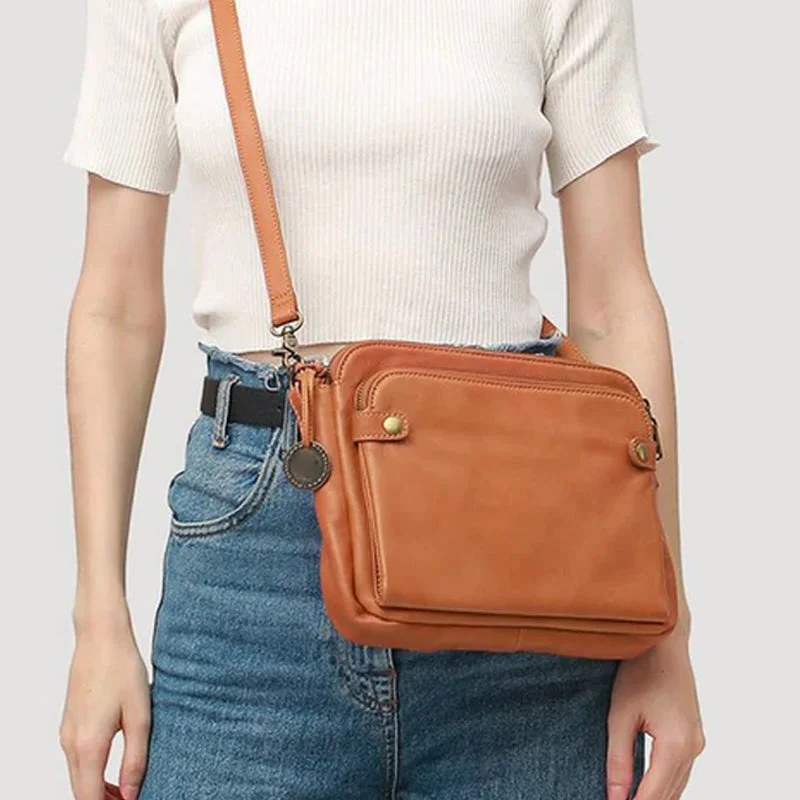 Organized women's three-layer leather crossbody bag, perfect for securely carrying everyday essentials.