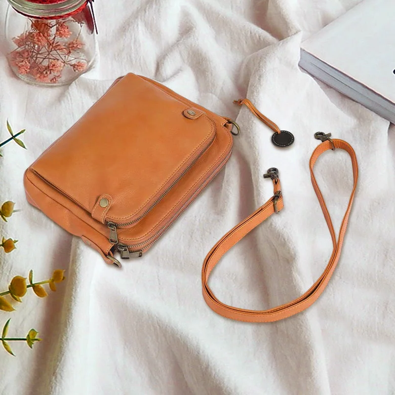 Woman carrying a chic three-layer leather crossbody bag, perfect for on-the-go organization.