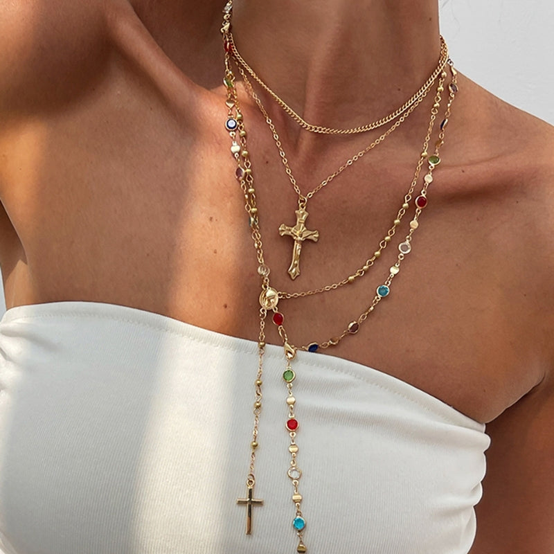 Women's 4-piece layered necklace set with cross pendants, elegant gold & silver jewelry, spiritual crystal accents.