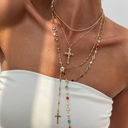 Women's 4-piece layered necklace set with cross pendants, elegant gold & silver jewelry, spiritual crystal accents.