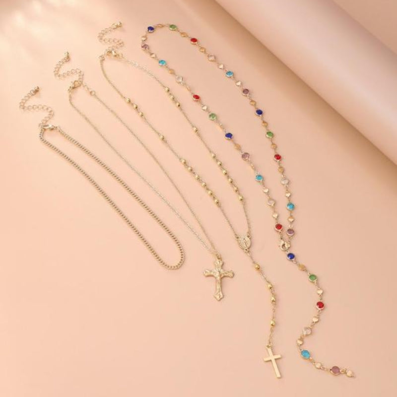 Versatile women's 4-piece layered cross necklace set, spiritual gold and silver pendants for elegant jewelry styling.