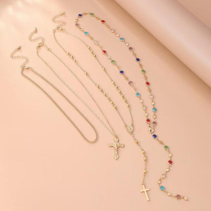 Versatile women's 4-piece layered cross necklace set, spiritual gold and silver pendants for elegant jewelry styling.