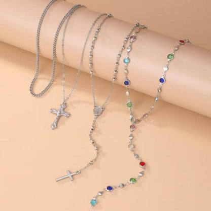 Women's 4-piece layered cross necklace. Elegant gold & silver pendant set with crystal accents for spiritual style.