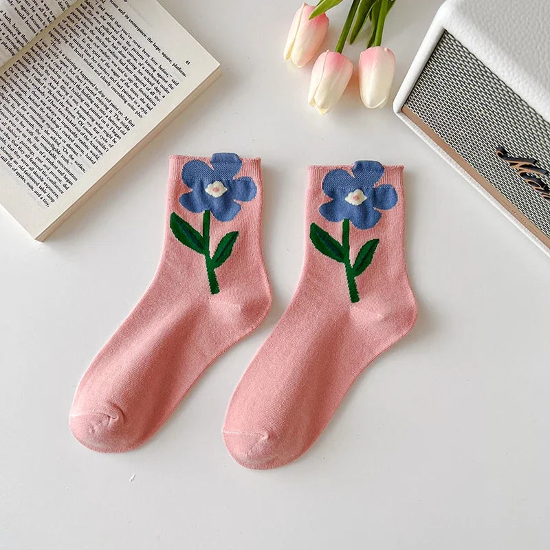 Group of 5 comfortable women's floral socks, showcasing unique patterns. Mid-calf cotton blend for daily style.