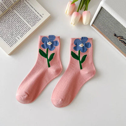Group of 5 comfortable women's floral socks, showcasing unique patterns. Mid-calf cotton blend for daily style.