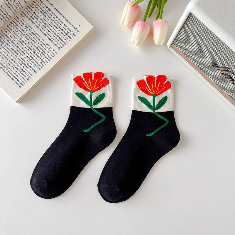 Women's patterned floral socks displayed, highlighting the mid-calf design. Cozy cotton blend everyday wear.