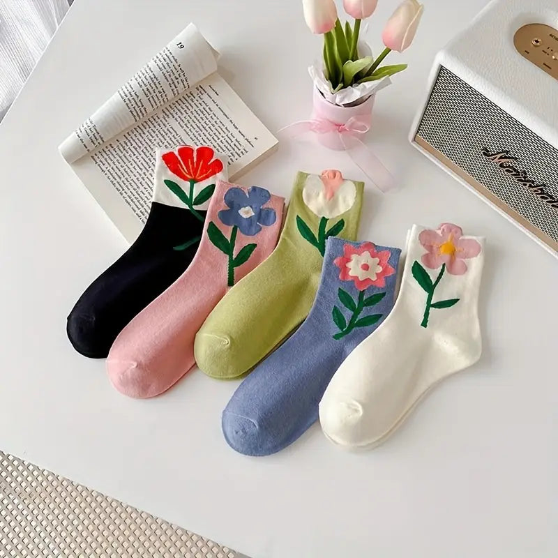 Close-up of vibrant floral patterns on women's mid-calf socks. Soft cotton blend for everyday comfort.