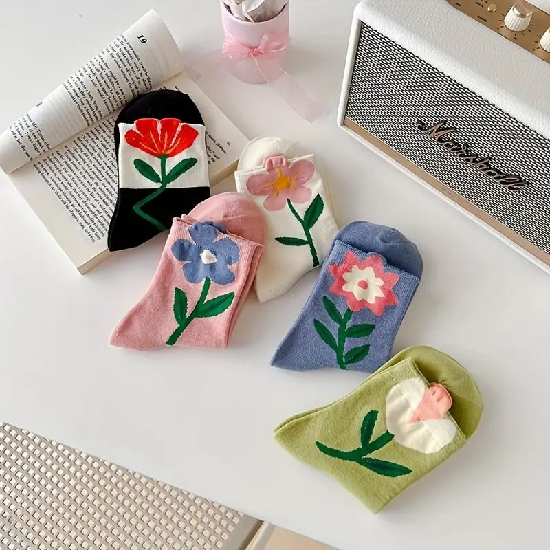 Five pairs of women's floral print socks, neatly folded. A comfortable cotton blend gift set for everyday wear.