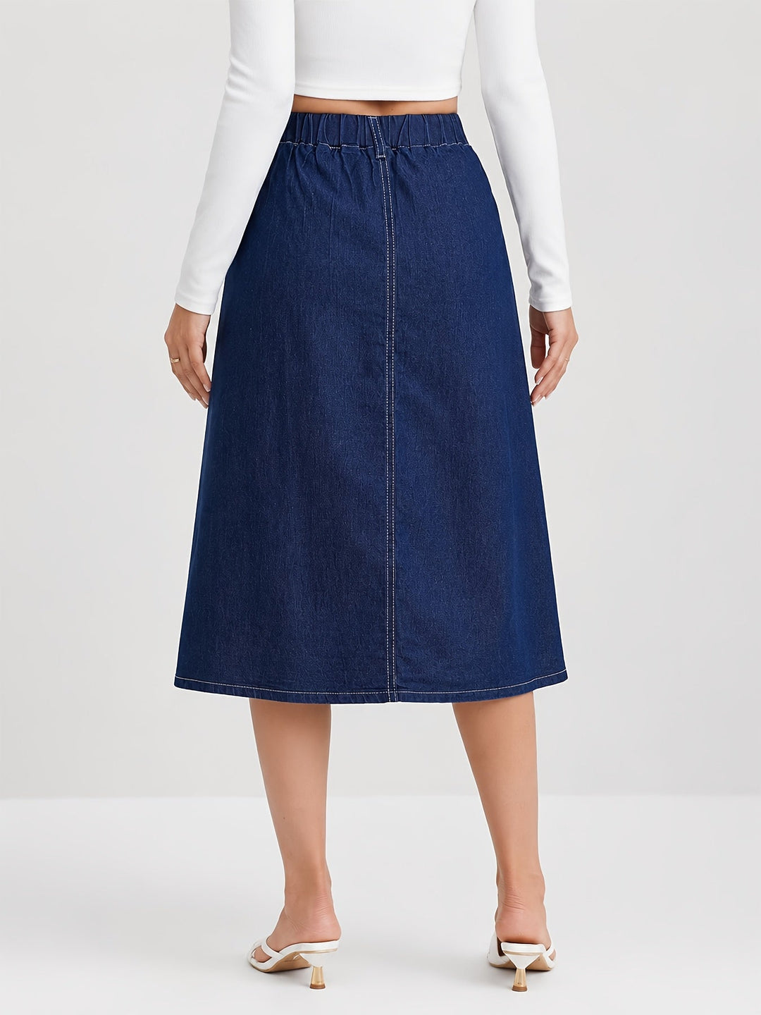 Pleated A-line women's denim midi skirt with stylish button front, offering a chic, casual look.