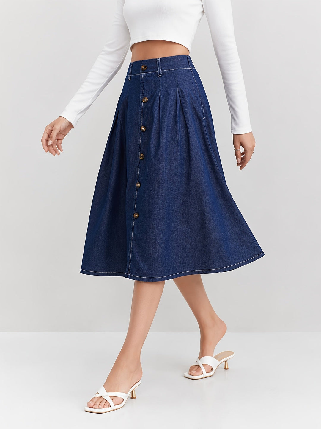 Versatile women's A-line blue denim midi skirt, button-front, pleated, great for everyday casual style.