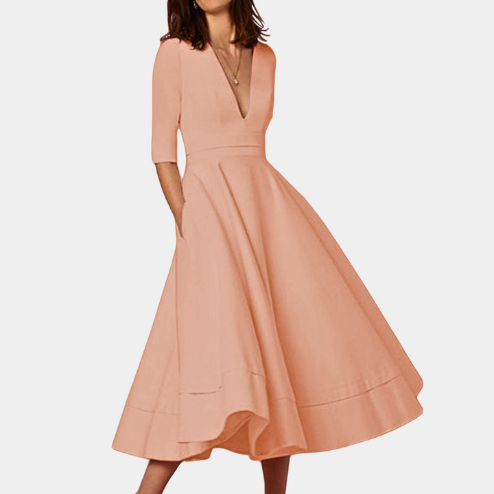 Full-length view of a women's A-line midi dress, showcasing its sleeveless design & elegant side slit.