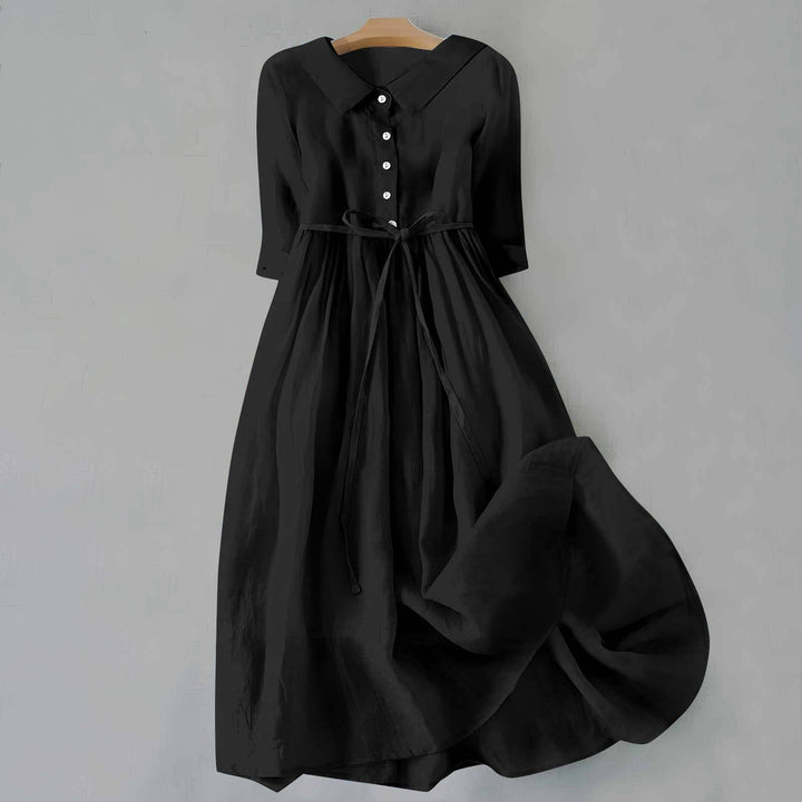 Flowy women's A-line midi dress with short sleeves, comfortable & chic for casual wear.