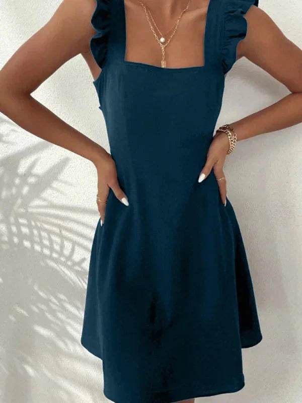 Trendy women's summer mini dress, A-line shape, with delicate ruffle straps and a charming bow back.