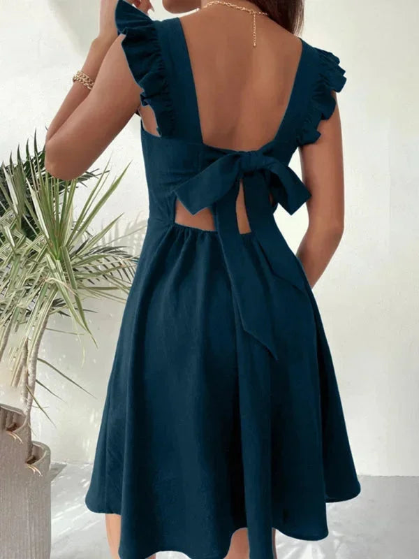 Sophisticated women's party A-line mini dress, complete with ruffle straps and an elegant bow back.