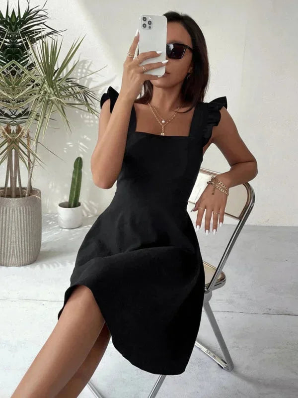 Women's elegant A-line mini dress with romantic ruffle straps and a tasteful bow detail on the back.