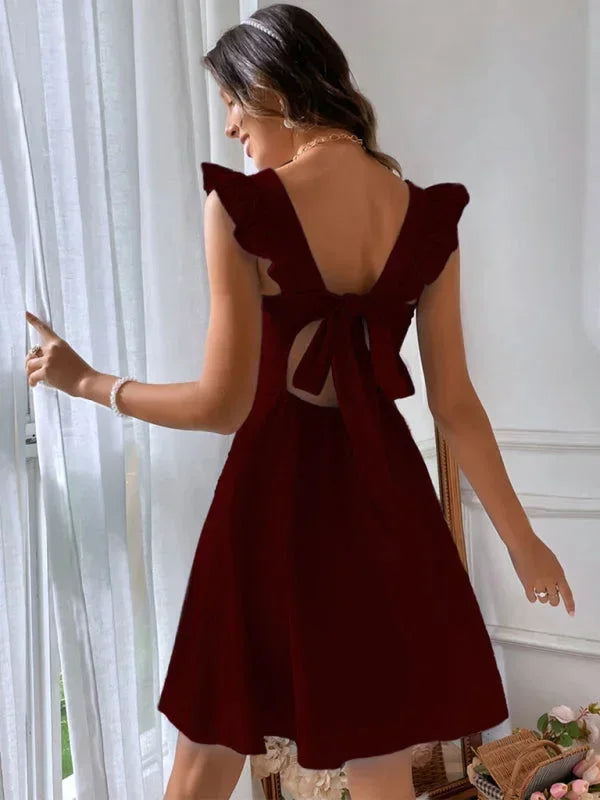 Fashionable women's ruffle strap mini dress, perfect for a flirty summer look with its bow back.