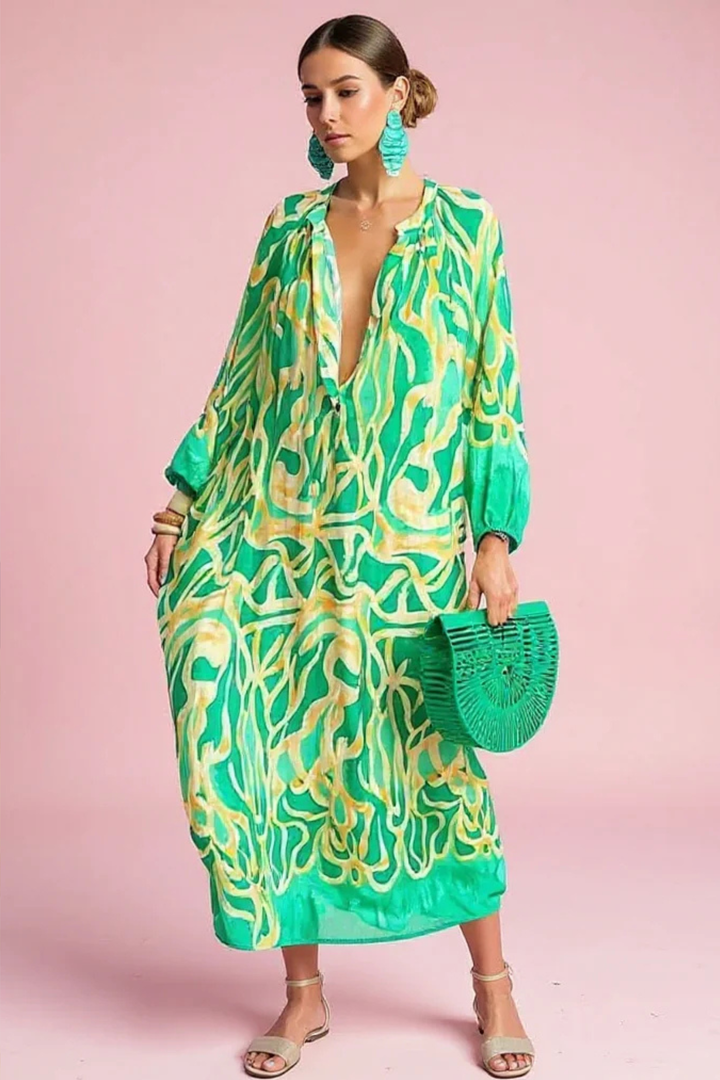 Women's abstract print V-neck kaftan maxi dress for resort wear. Flowy summer fashion, a stylish beach dress.