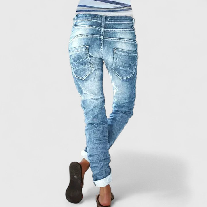 Trendy women's slim-fit acid wash jeans with unique contrast stitching, perfect for casual everyday wear.
