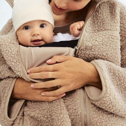 Stylish women's adaptive maternity jacket for fall/winter, perfect for comfortable baby carrying & pregnancy fashion.