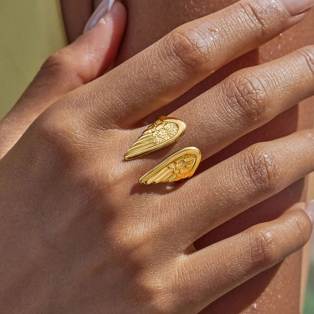 Chic gold-plated adjustable women's ring with delicate angel wings, perfect for protection & empowerment.