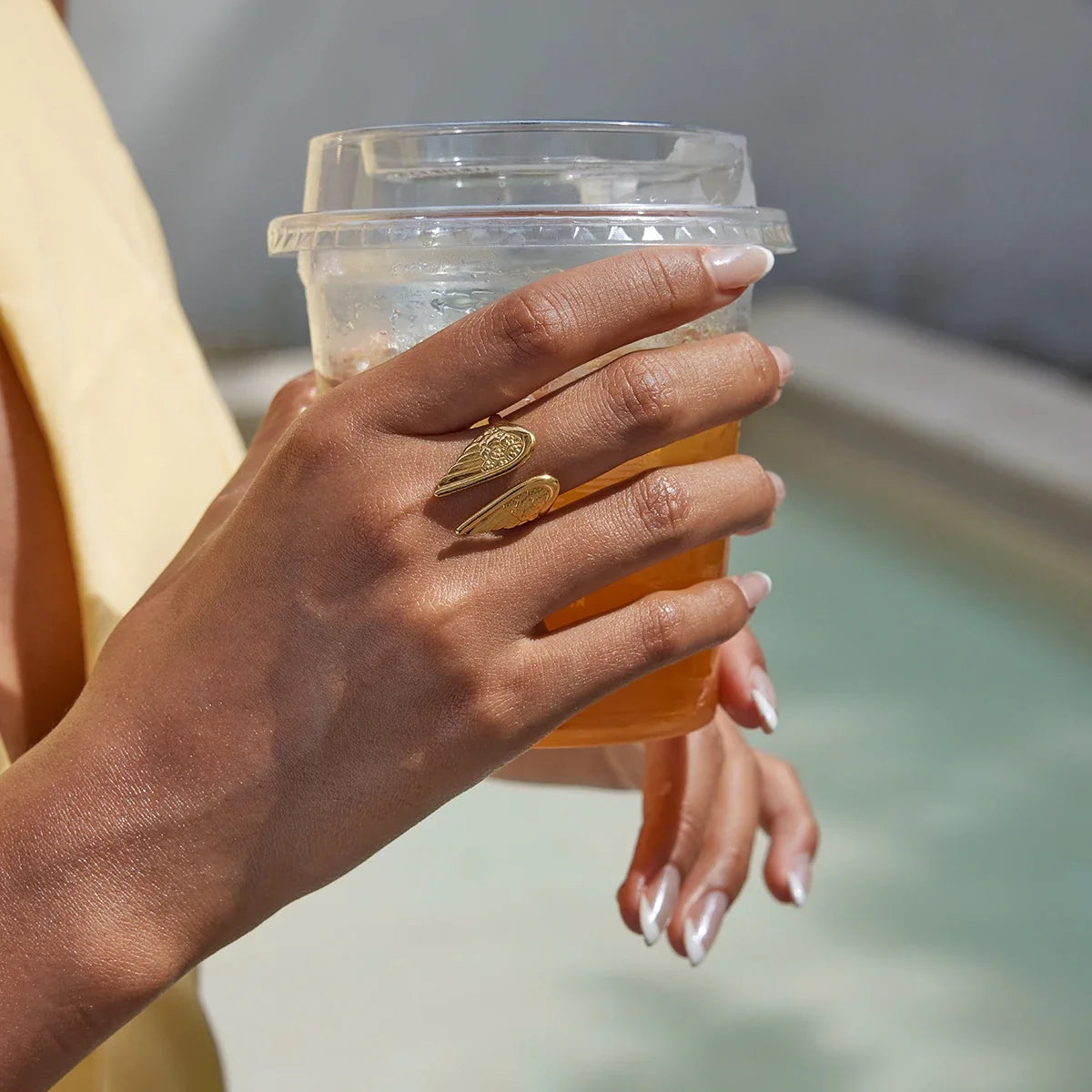 Elegant women's fashion accessory: adjustable gold-plated angel wings ring, symbolizing protection & strength.