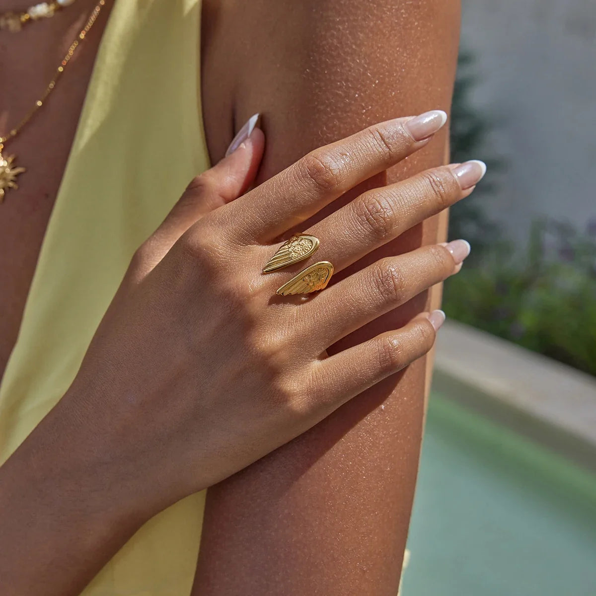 Adjustable women's gold-plated ring with intricate angel wings design. Stainless steel protection jewelry.