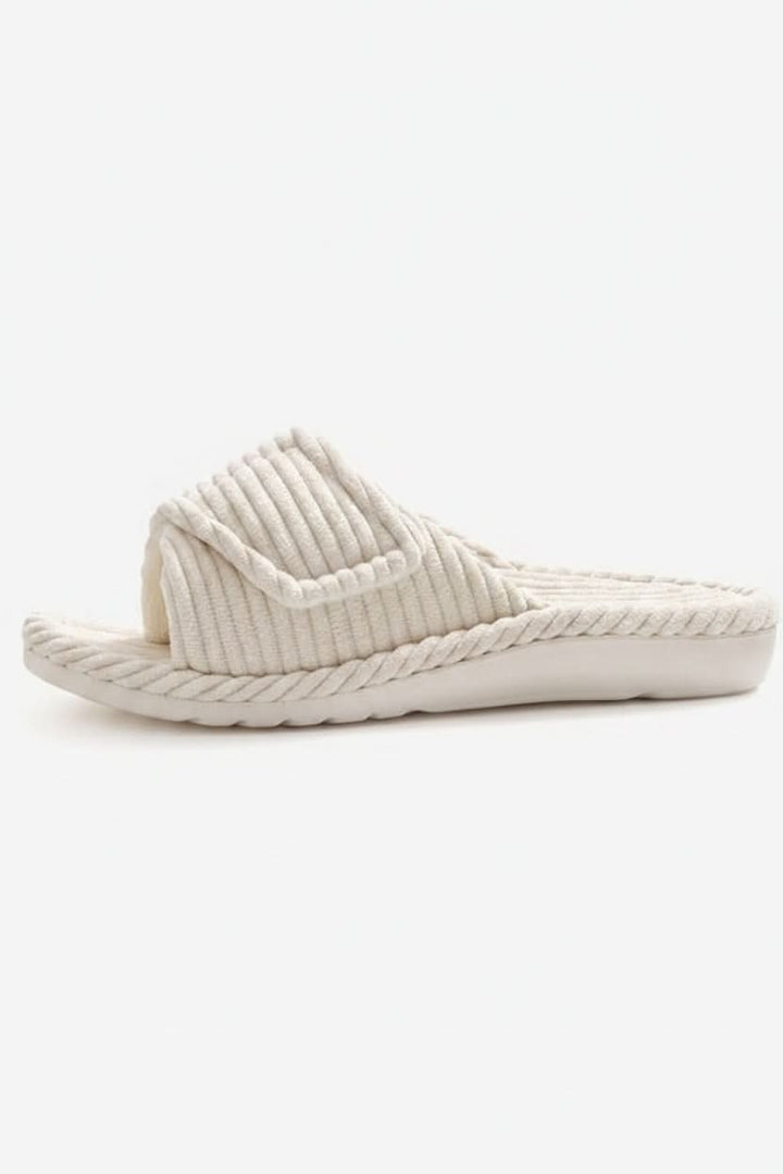Close-up of the adjustable strap on a women's open-toe slipper, offering custom comfort & a secure fit.