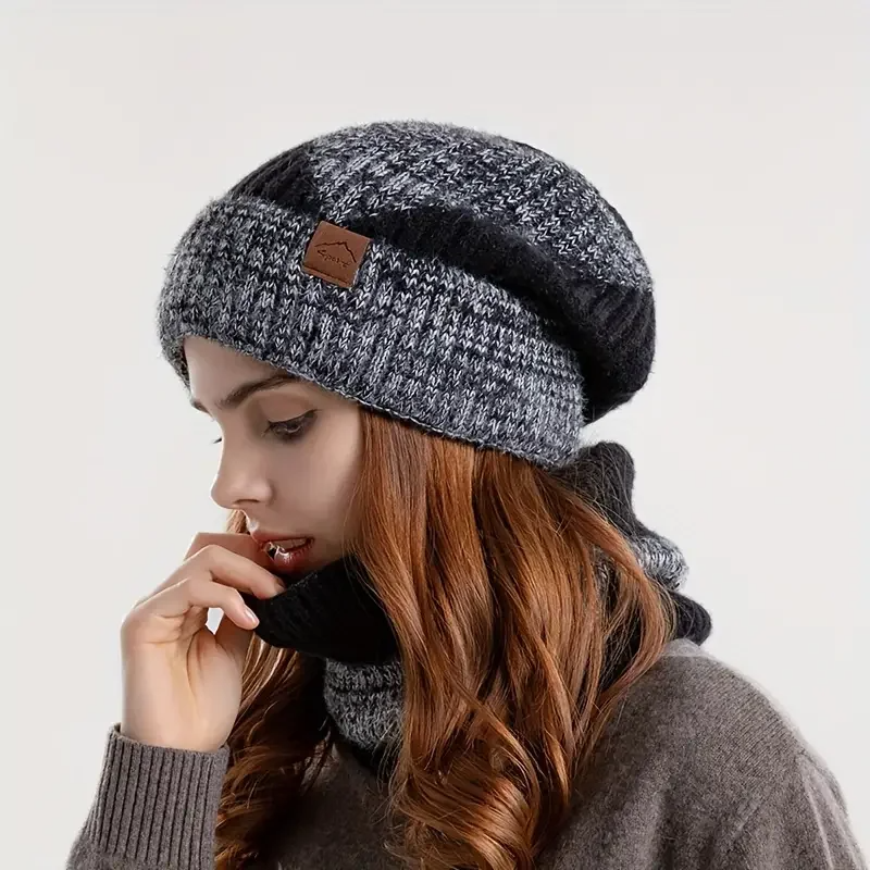 Woman wearing stylish Amara warm beanie and matching scarf set, perfect for elegant winter outfits and cold weather.