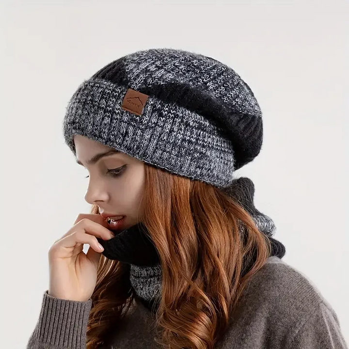 Woman wearing stylish Amara warm beanie and matching scarf set, perfect for elegant winter outfits and cold weather.