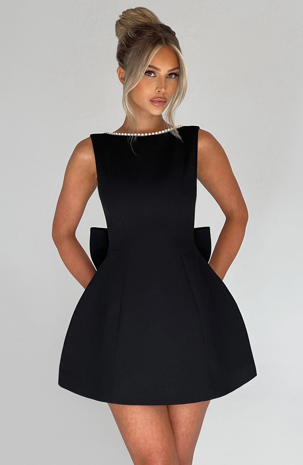 Black Amber elegant structured mini dress for women. Sleeveless design, perfect party & cocktail dress.