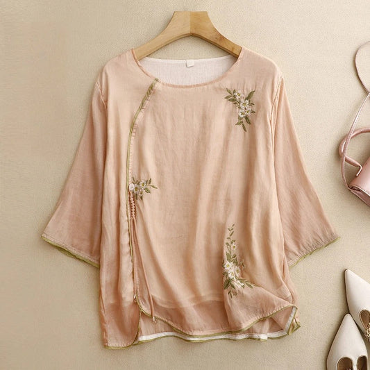 Women's Amber embroidered wrap blouse with elegant floral details, perfect for summer fashion.