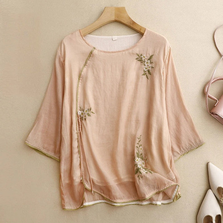 Women's Amber embroidered wrap blouse with elegant floral details, perfect for summer fashion.
