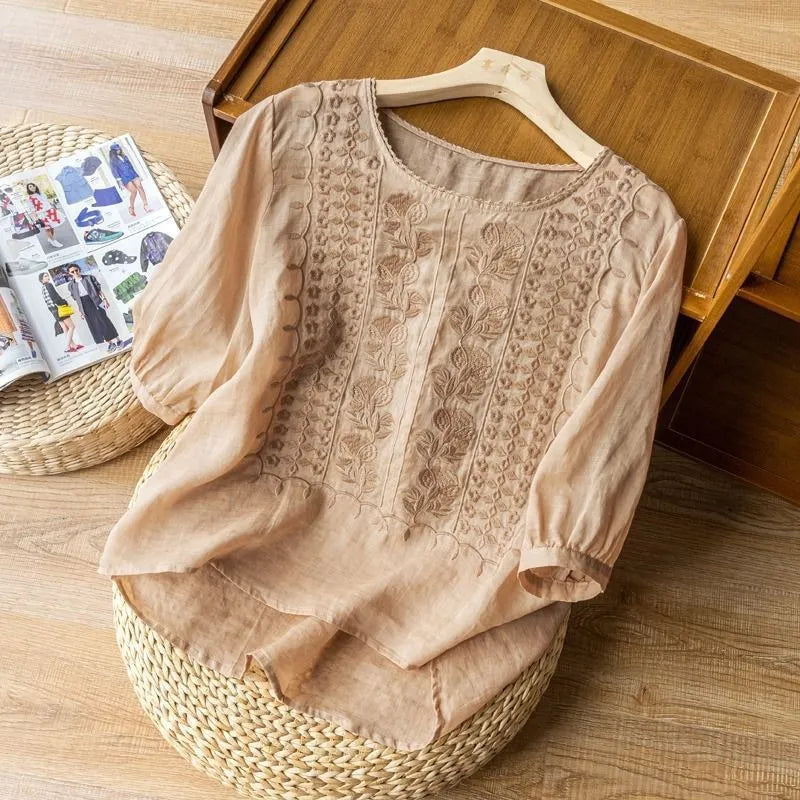 Beautiful women's Annelise blouse with floral embroidery, elegant puff sleeves, and a flattering high-low hem design.