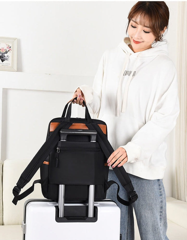 Anti-theft women's backpack for commute, water resistant. Lightweight oxford fabric, ideal everyday security bag.