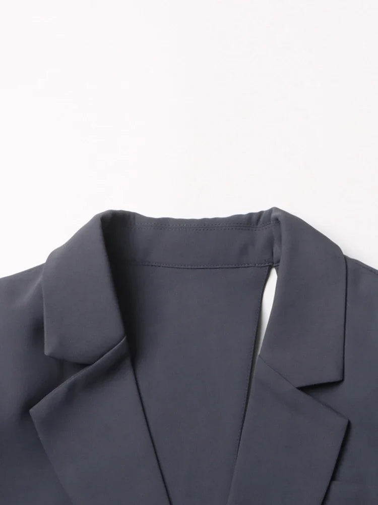 Modern women's asymmetric blazer with stylish cutout & dramatic bell sleeves. Sophisticated formal wear.