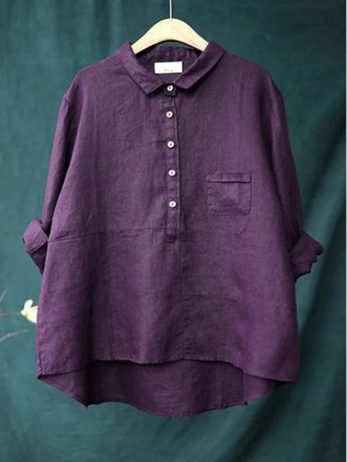 Relaxed fit women's blouse featuring a unique asymmetrical hem. Comfortable long sleeve button-up for casual style.